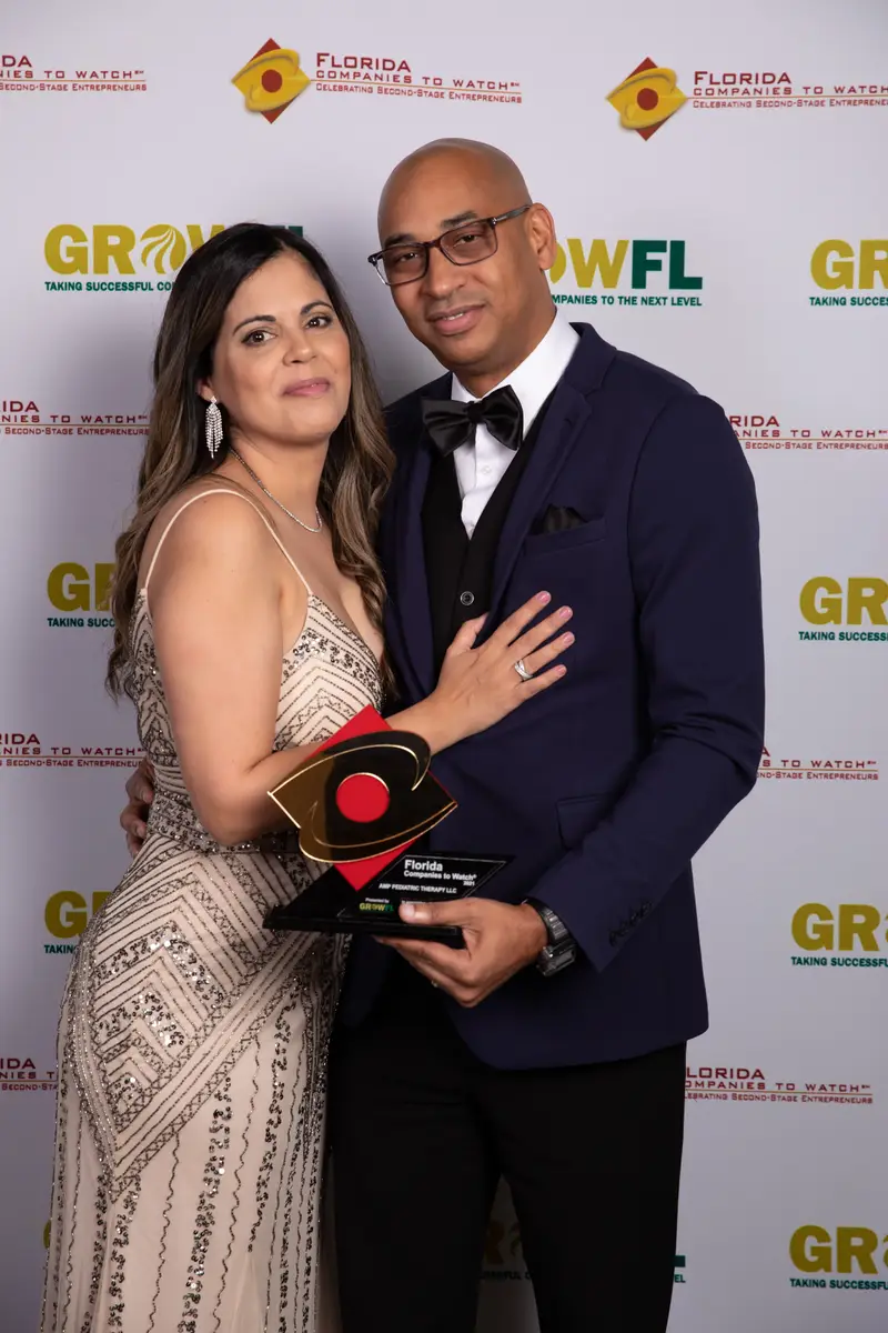 Founders Alexander and Alexandra Perez holding the Florida Companies to Watch award