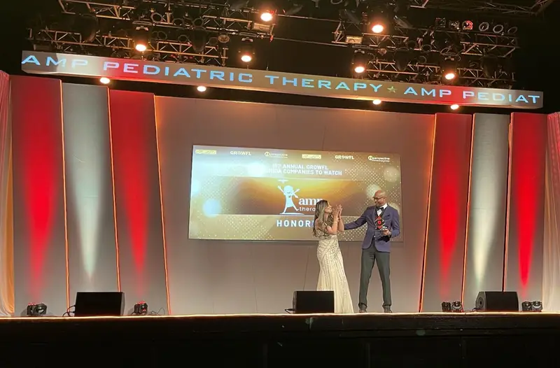 Alexander and Alexandra Perez on stage as AMP Pediatric Therapy is honored at the GrowFL Florida Companies to Watch gala